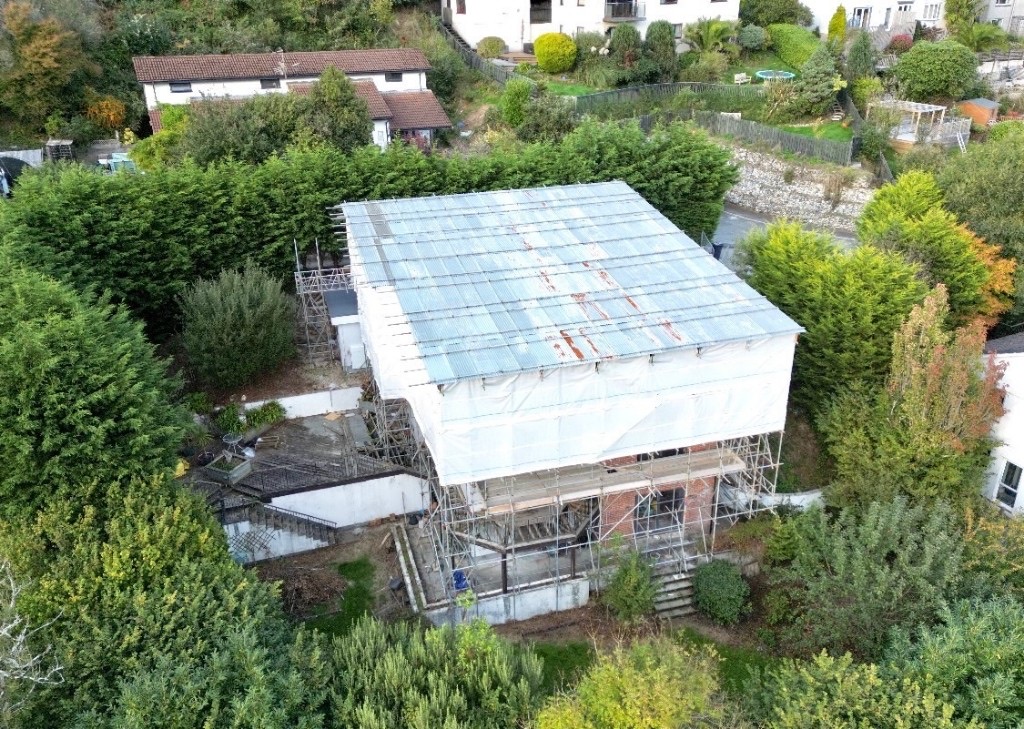 Aerial view of a house under scaffolding and a temporary roof during insurance reinstatement works